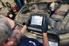 Mechanic working on a vehicle at Amtech Auto Care Inc. - image #2