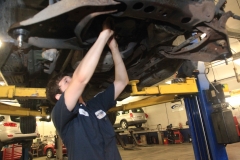 Mechanic working on a vehicle at Amtech Auto Care Inc. - image #6