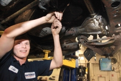 Mechanic working on a vehicle at Amtech Auto Care Inc. - image #11