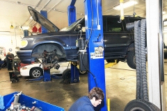 Mechanic working on a vehicle at Amtech Auto Care Inc.