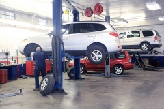 Mechanic working on a vehicle at Amtech Auto Care Inc. - image #5